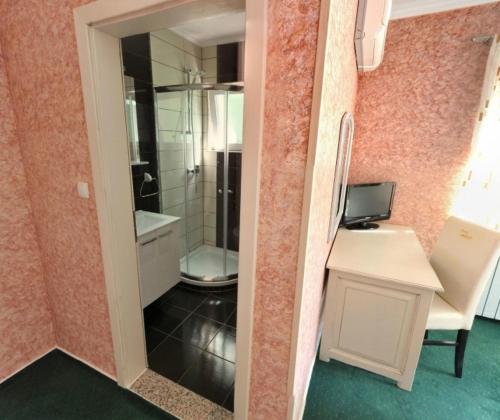 La salle de bains est pourvue de toilettes, d'un lavabo et d'un miroir. dans l'établissement Motel Most, à Ljubuški