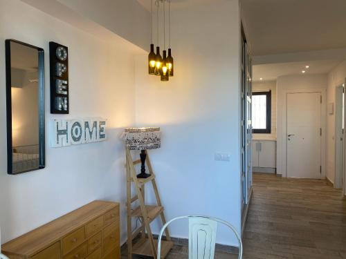 a hallway with a mirror and a table and a ladder at Aloha Playa in Benalmádena