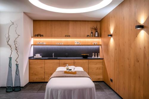 a hospital room with a bed and a sink at Hotel Auenhof in Lech am Arlberg