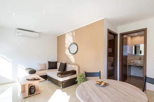 a living room with a couch and a table at Elisabeth Luxury Villas in Vourvourou