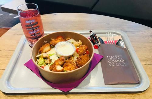 a tray with a bowl of food on a table at Ibis Niort Est Mendes France in Niort