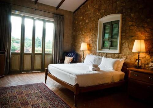 a bedroom with a bed with a teddy bear on it at La Toscana in Suan Phung