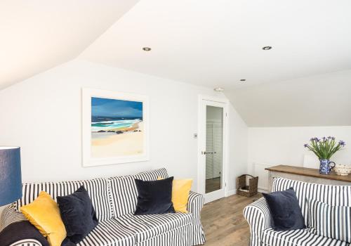a living room with two couches and a painting on the wall at Hideaway in North Berwick