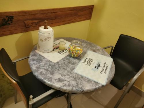 a table in a room with a table with chairs and a tableablish at Résidences ASKÉ in Abomey-Calavi