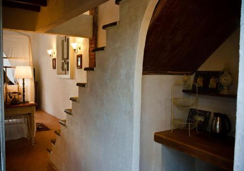 a living room with a staircase in a house at La Toscana in Suan Phung