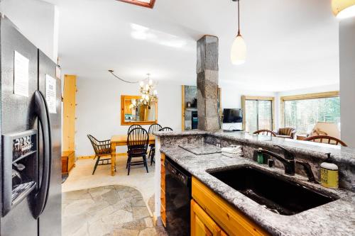 a kitchen with a sink and a refrigerator at The Summit 67 in Old Mammoth