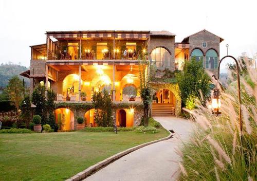 a large house with a lot of windows at La Toscana in Suan Phung