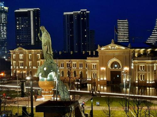 a statue in front of a building at night at Belgrade City Hotel in Belgrade