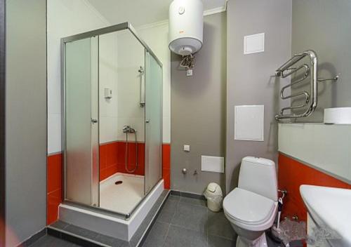 a bathroom with a shower and a toilet and a sink at S&M Apartments in Kyiv