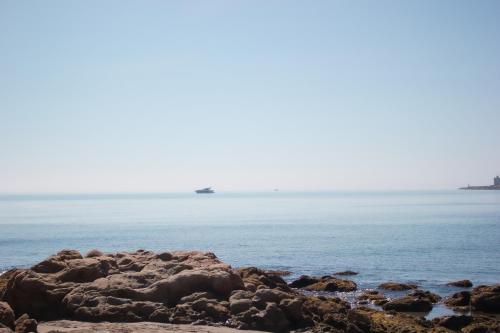 a view of the ocean from a rocky beach at Hotel Patricia in Torreguadiaro