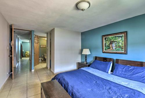 Un dormitorio azul con una cama y una pared azul. en Heavenly Aguadilla Condo with Infinity Pool and Views!, en Aguadilla