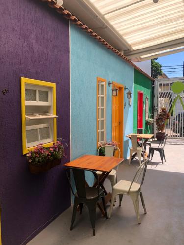 a patio with a table and chairs and a building at Anhembi Hostel in Sao Paulo