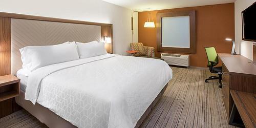 a hotel room with a large bed and a desk at Holiday Inn Express & Suites Dayton North - Vandalia, an IHG Hotel in Dayton