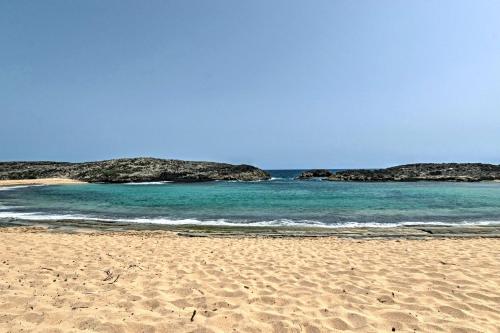 a sandy beach with two islands in the water at Tropical Caribbean Bungalow with Ocean Views and Pool in Manati