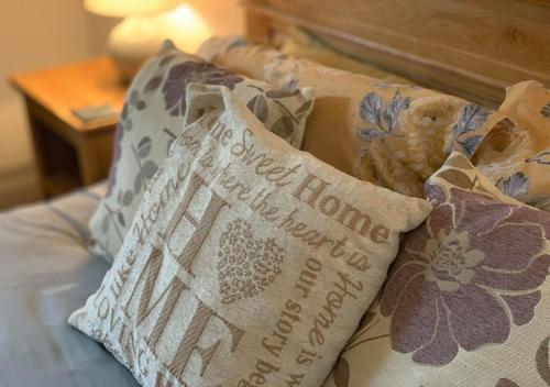 a pillow sitting on top of a bed at Smithy Cottage in Berriew