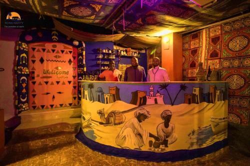 a bar with a painting on the wall of a room at Nuba Narty in Aswan