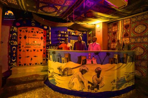 a room with a painting on the wall of a bar at Nuba Narty in Aswan