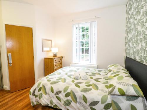 a bedroom with a bed and a window at Plas Coch in St Asaph