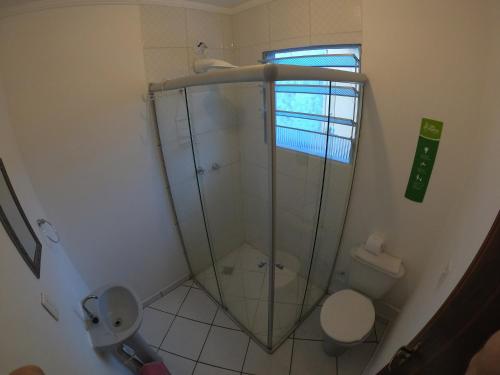 a bathroom with a toilet and a glass shower at Che Lagarto Paraty in Paraty