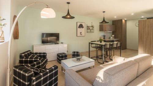 un salon avec un canapé et une table dans l'établissement Côté Jardin avec Jacuzzi Privatif et parking privé, à Sarlat-la-Canéda