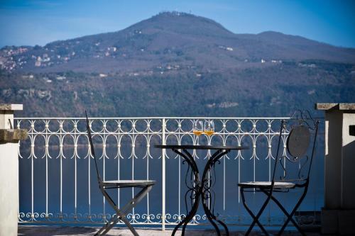 a table and chairs on a balcony with a mountain at Villa Forti in Castel Gandolfo