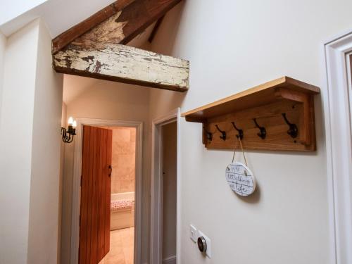 a hallway with a wooden beam on the wall at Combine Shed in Bidford