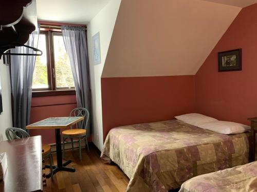 Voodi või voodid majutusasutuse L'Auberge Refuge du Trappeur toas