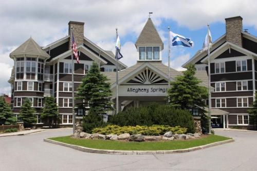 a large building with flags in front of it at Allegheny Spg - Cozy Condo Ski from our patio in Dunmore