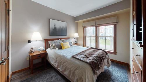 a bedroom with a large bed and a window at Allegheny Spg - Cozy Condo Ski from our patio in Dunmore