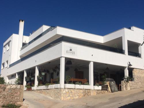 a white building with the word dong on it at Exclusive 2 Bedroom Seafront Suite with jacuzzi in Zavala