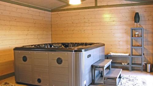a kitchen with a stove in a wooden room at Il Lonfo in Pieve Fosciana