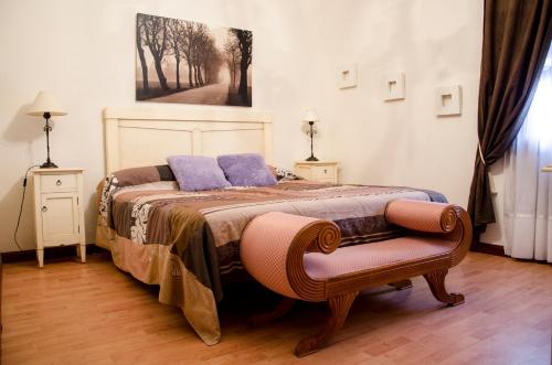 a bedroom with a bed with purple pillows on it at Hotel Algete in Algete