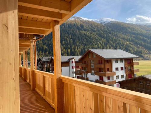 a wooden balcony with a view of a mountain at Sporthotel Oberwald in Oberwald