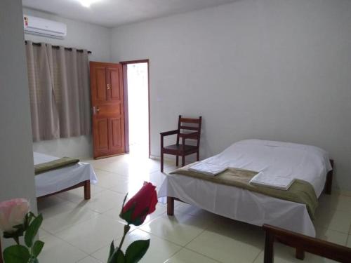 En eller flere senge i et værelse på Pousada Sol de Minas