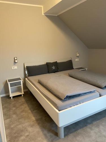a bedroom with a large bed in a room at Hotel Kellermann in Overath