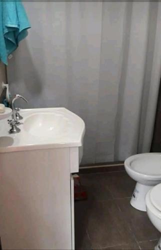a bathroom with a white sink and a toilet at COMPLEJO DE VARIOS LOFT EN RAFAELA A 100 METROS de la RUTA 34 in Rafaela