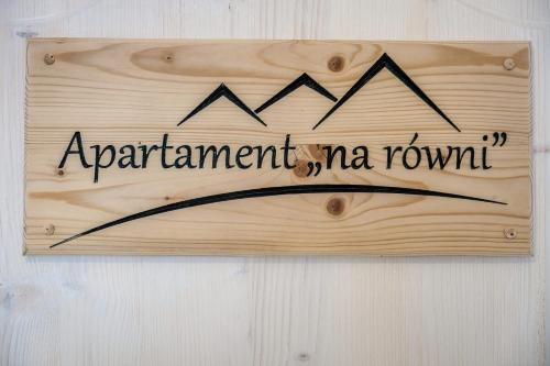 a sign on a wall that says apartment mma room at Willa w Ubocy - "Jacuzzi i Sauna w ofercie dodatkowo płatnej" in Murzasichle
