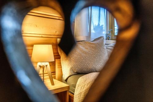 a view of a bedroom with a bed and a lamp at Willa w Ubocy - "Jacuzzi i Sauna w ofercie dodatkowo płatnej" in Murzasichle