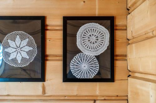 two framed pictures of flowers on a wall at Willa w Ubocy - "Jacuzzi i Sauna w ofercie dodatkowo płatnej" in Murzasichle