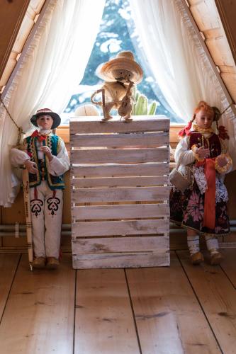 three dolls are standing in a room in a tent at U Leona in Gorlice