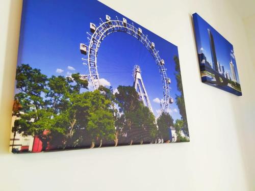 a picture of a ferris wheel on a wall at Cosy Park Apartment City Center in Vienna