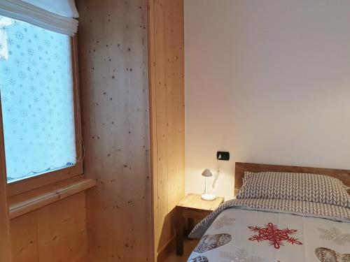 a bedroom with a bed and a window at CASA TANTI in Bormio