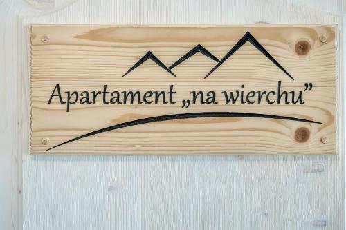 a sign that reads apartment management ma waterfall on a wooden wall at Willa w Ubocy - "Jacuzzi i Sauna w ofercie dodatkowo płatnej" in Murzasichle