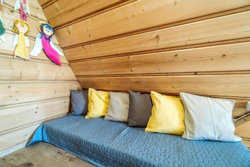 a bed in a room with wooden walls at Willa w Ubocy - "Jacuzzi i Sauna w ofercie dodatkowo płatnej" in Murzasichle
