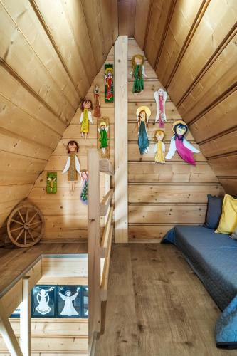 a cabin with wooden walls and a bed in a room at Willa w Ubocy - "Jacuzzi i Sauna w ofercie dodatkowo płatnej" in Murzasichle