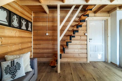 a staircase in a room with wooden walls and wooden floors at Willa w Ubocy - "Jacuzzi i Sauna w ofercie dodatkowo płatnej" in Murzasichle