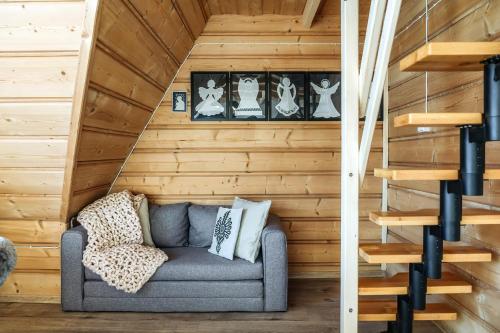 a room with a couch in a wooden wall at Willa w Ubocy - "Jacuzzi i Sauna w ofercie dodatkowo płatnej" in Murzasichle