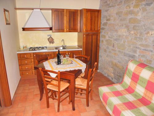 a kitchen with a table and chairs and a sink at Aurora in Gubbio