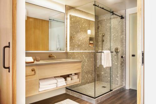 a bathroom with a shower and a sink at Mission Pacific Beach Resort, part of JdV by Hyatt in Oceanside