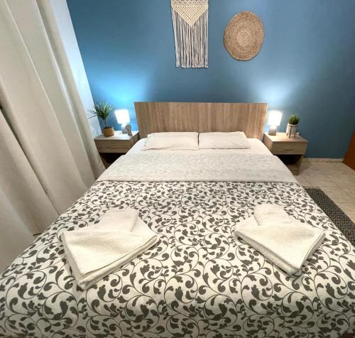 a bedroom with a large bed with two pillows on it at Anastasias house near Athens airport in Spáta